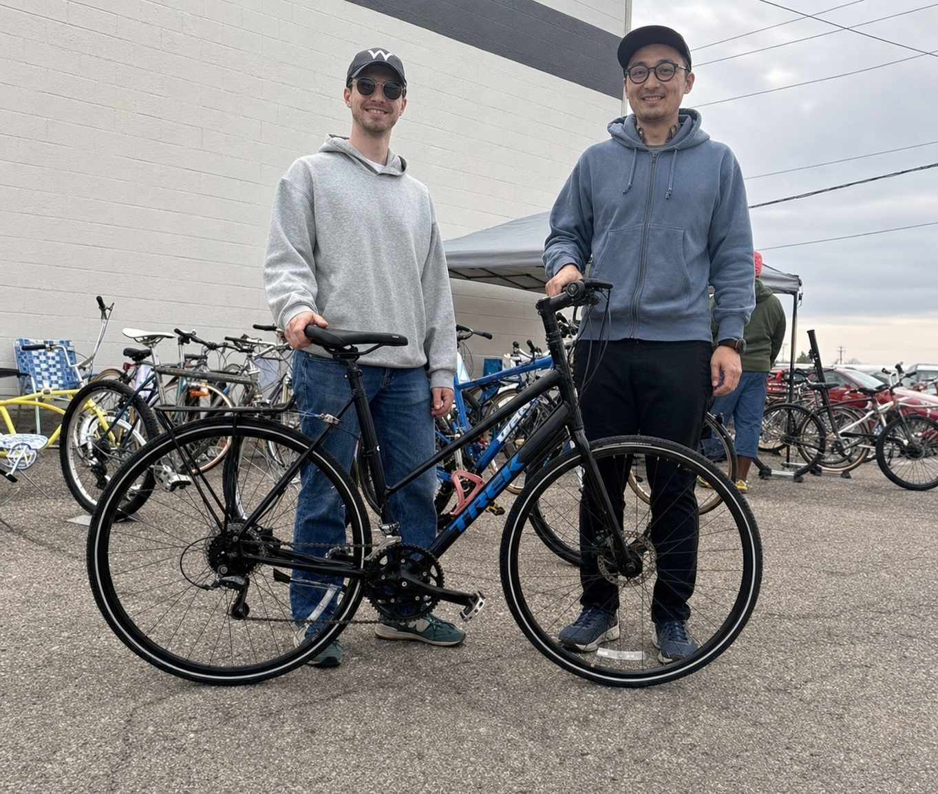 Two people with a bike at YYC Bike Swap